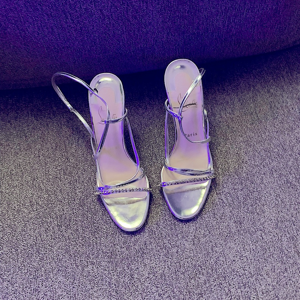 A Pair of Christian Louboutin Red botton shoes